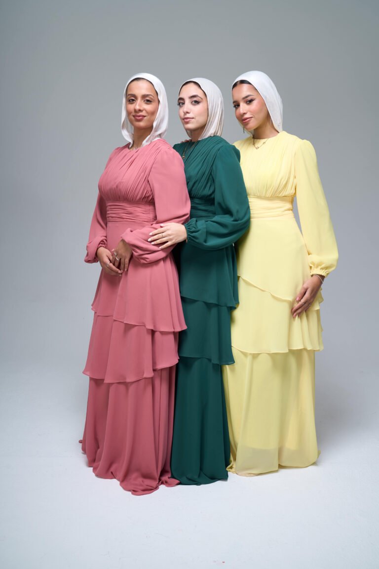 Three layered chiffon modest evening dresses in pink, green and yellow with white hijabs in studio photoshoot