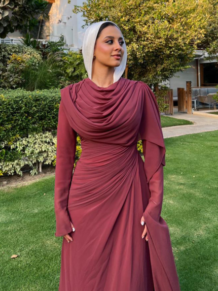 Burgundy draped modest evening dress with white hijab in garden