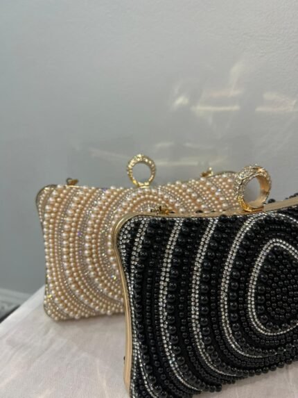 Two beaded evening clutch bags, one black and silver and one pearl white, with gold ring clasps