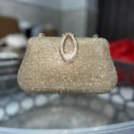 Gold rhinestone evening clutch with oval ring handle