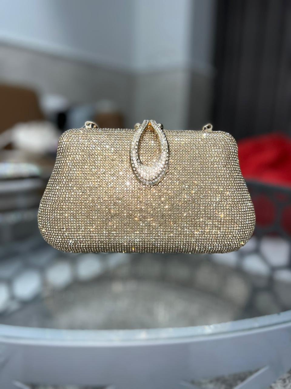 Gold rhinestone evening clutch with oval ring handle