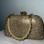 Gold glitter clutch bag with braided strap