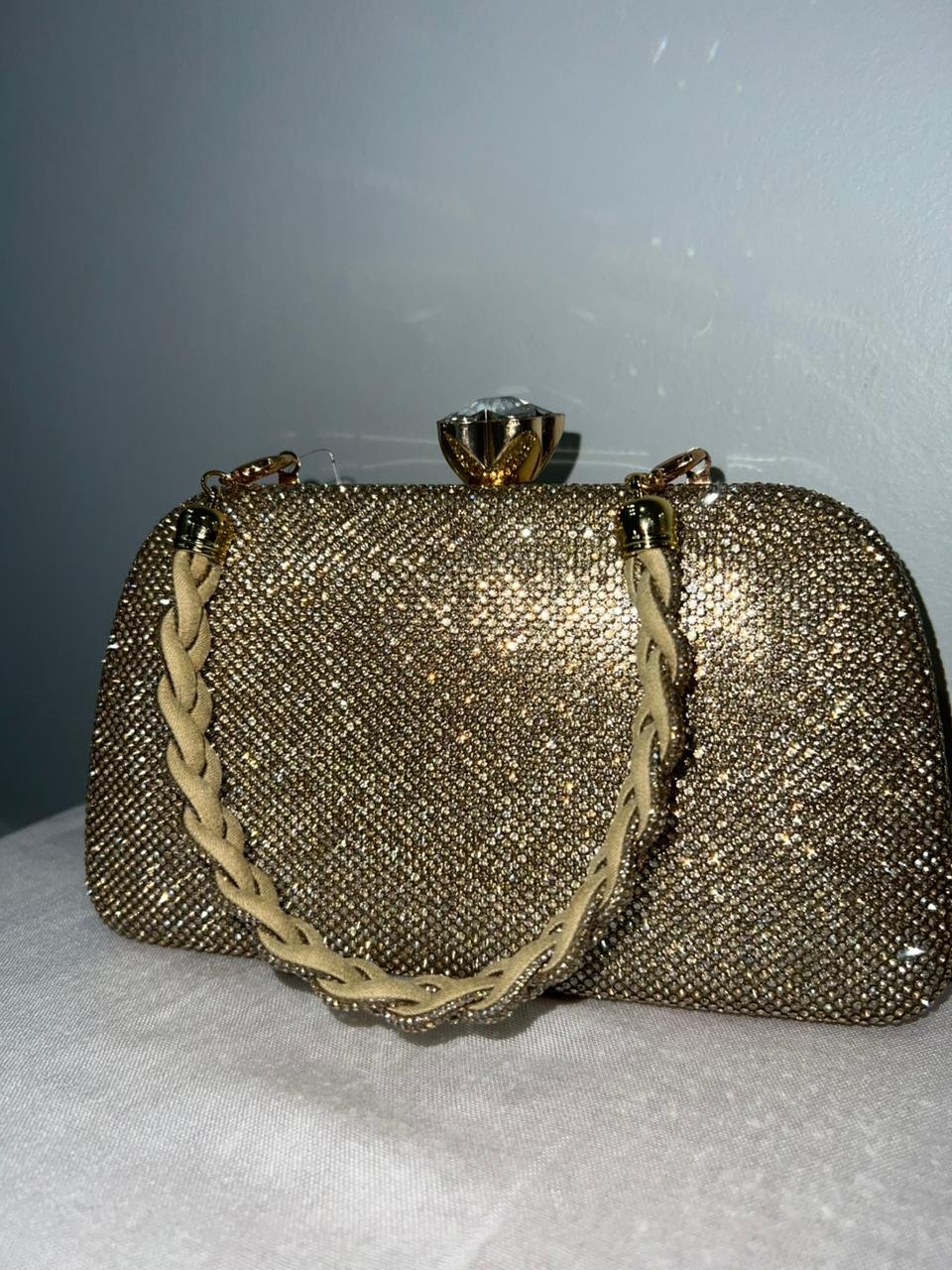 Gold glitter clutch bag with braided strap